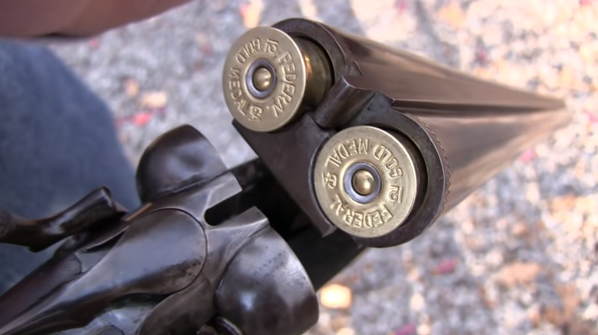 opened double barreled shotgun with two cartridges